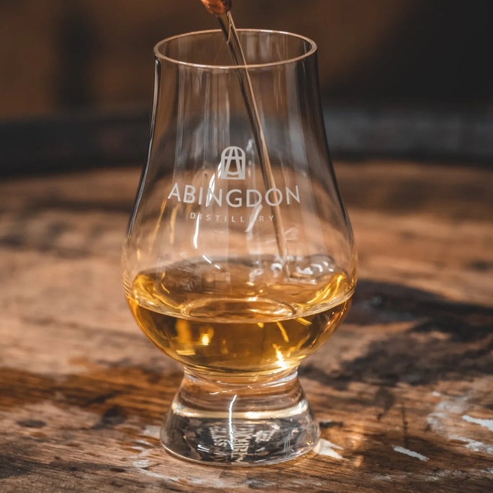 A clear glass whisky tasting glass with &