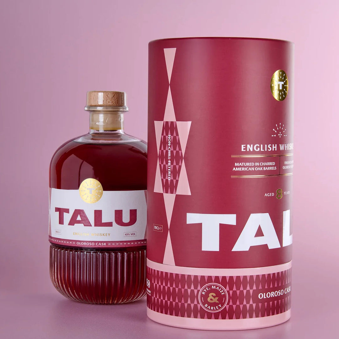 TALU Oloroso Cask English Whiskey bottle and cylindrical packaging on a pink background