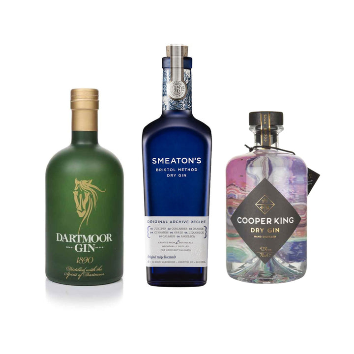 Three gin bottles from Dartmoor Gin, Smeaton's Bristol Dry Gin, and Cooper King Dry Gin on a white background.