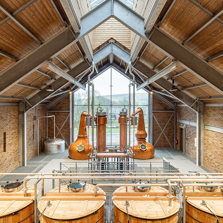 Copper pot stills and wooden washbacks inside Ad Gefrin distillery, Wooler