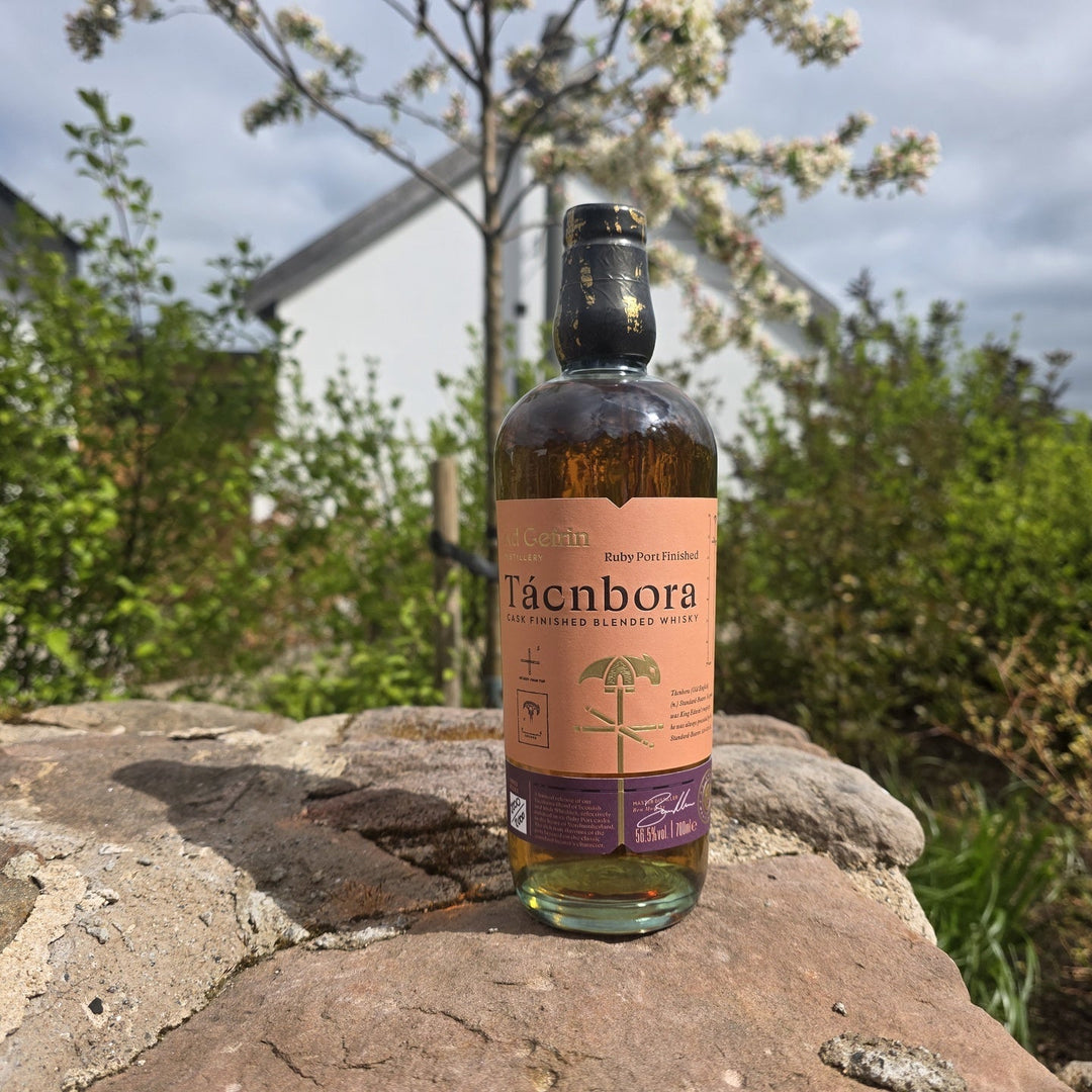 A bottle of Tacnbora Ruby Port Cask Limited Edition Whisky on a rock surface outside