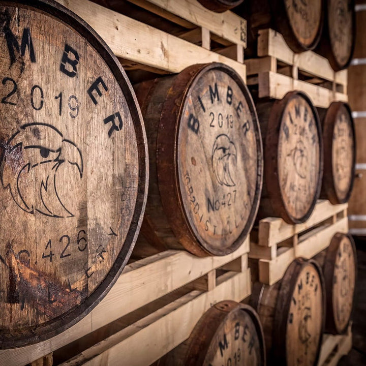 A close-up of a wooden whiskey barrel with &