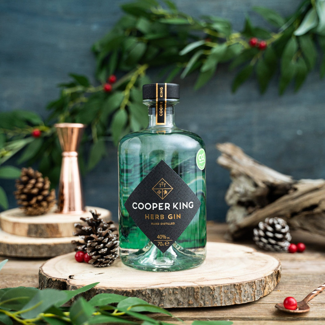 Bottle of Cooper King Herb Gin on a wooden plank