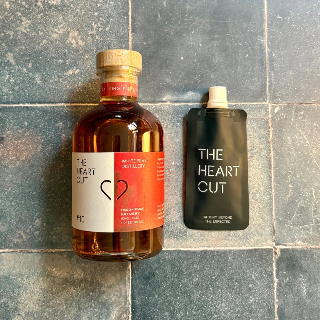 Bottle and 3cl pouch of 'The Heart Cut' #10 whisky on a tiled surface.