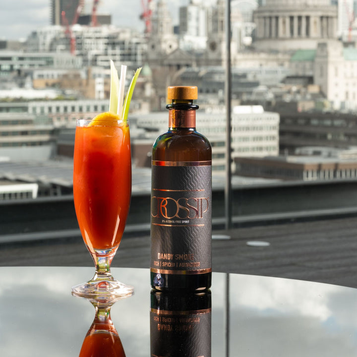 Bottle of Crossip Dandy Smoke with a cocktail in a glass against a cityscape background