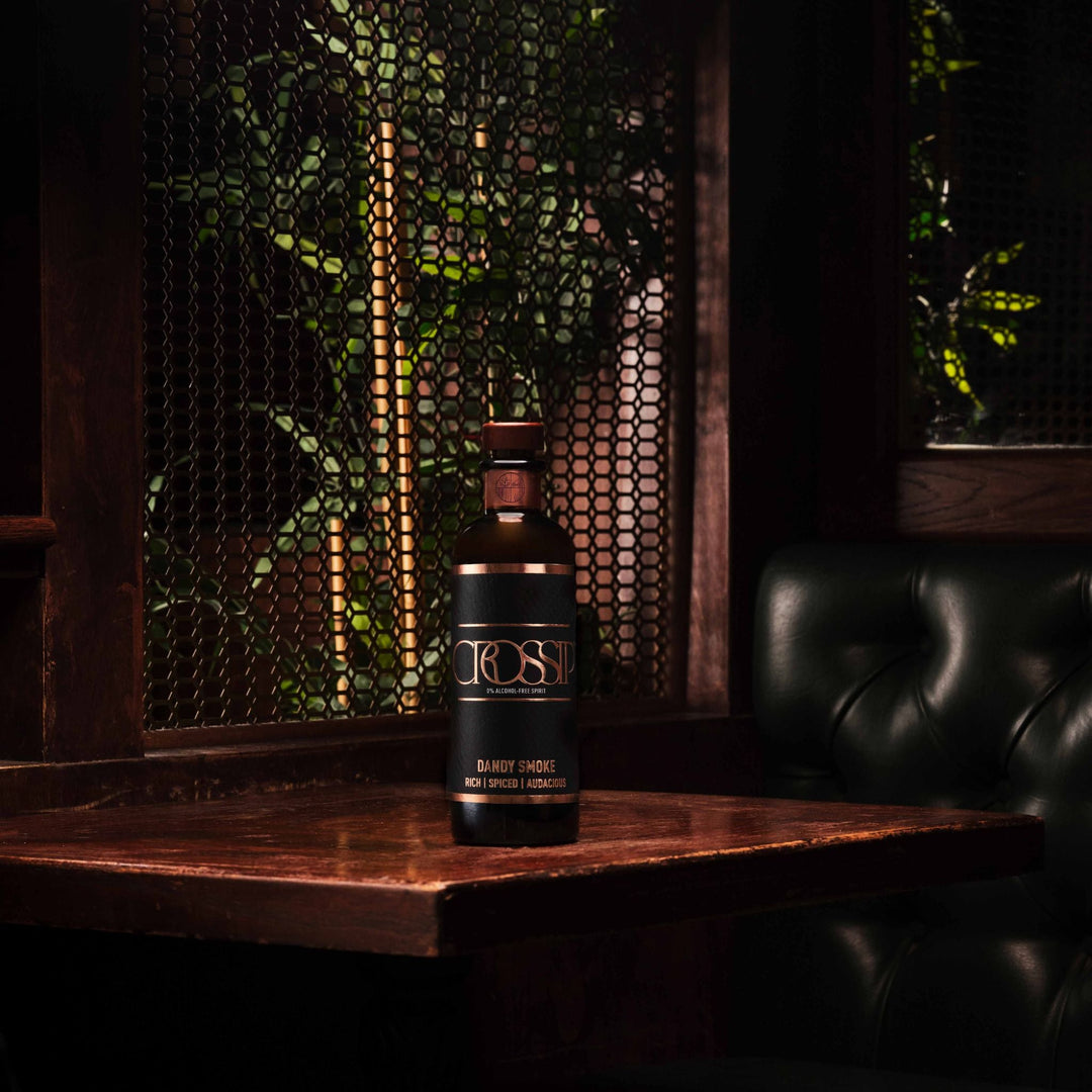Bottle of Crossip Dandy Smoke on a wooden table with a dark background