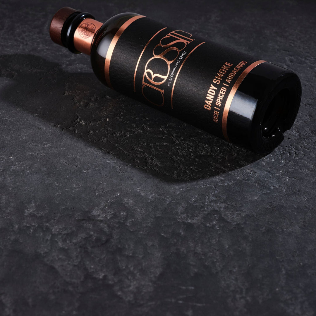 Crossip Dandy Smoke Black bottle with bronze accents on a dark textured surface