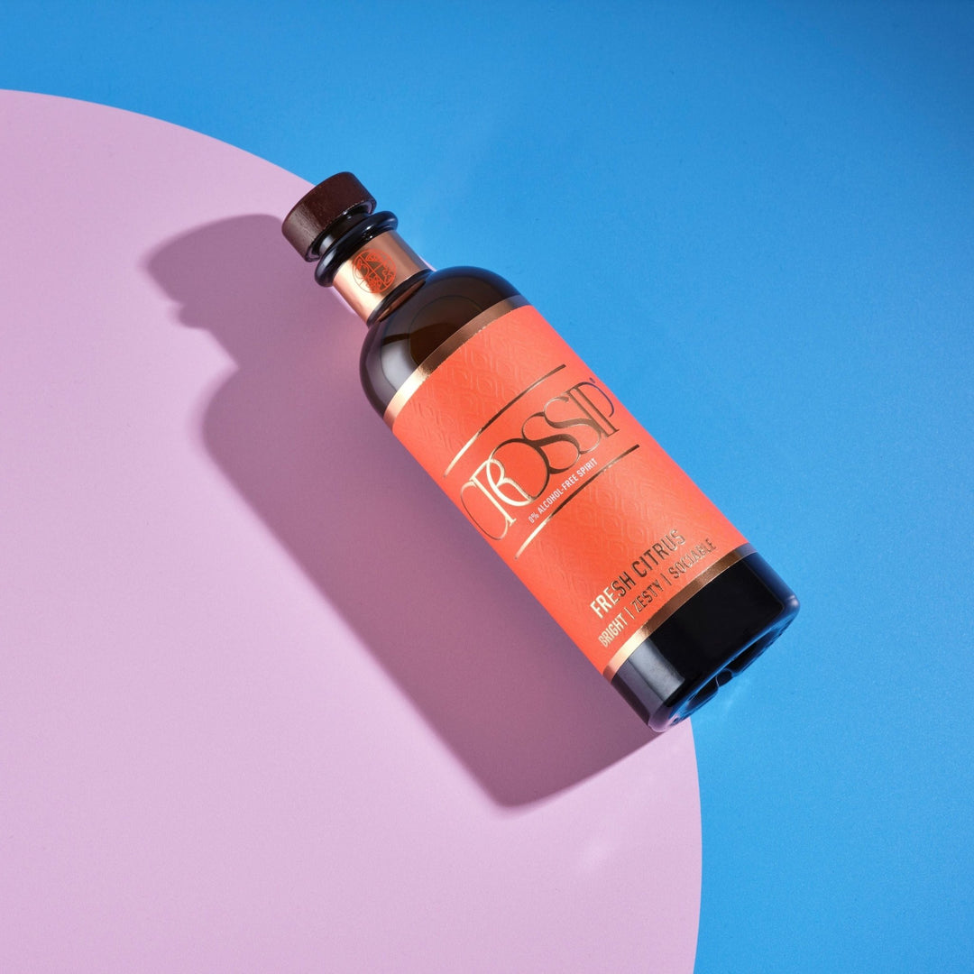 Bottle of Crossip Fresh Citrus on a pink and blue background