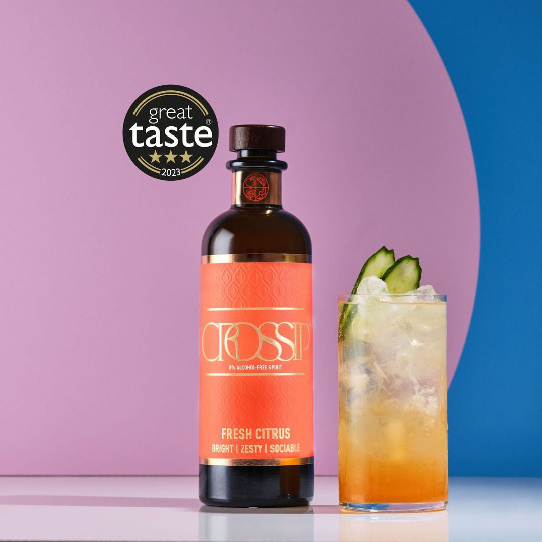 Bottle of Crossip Fresh Citrus with a cocktail garnished with a cucumber slice on a pink and blue background, featuring the Great Taste award.