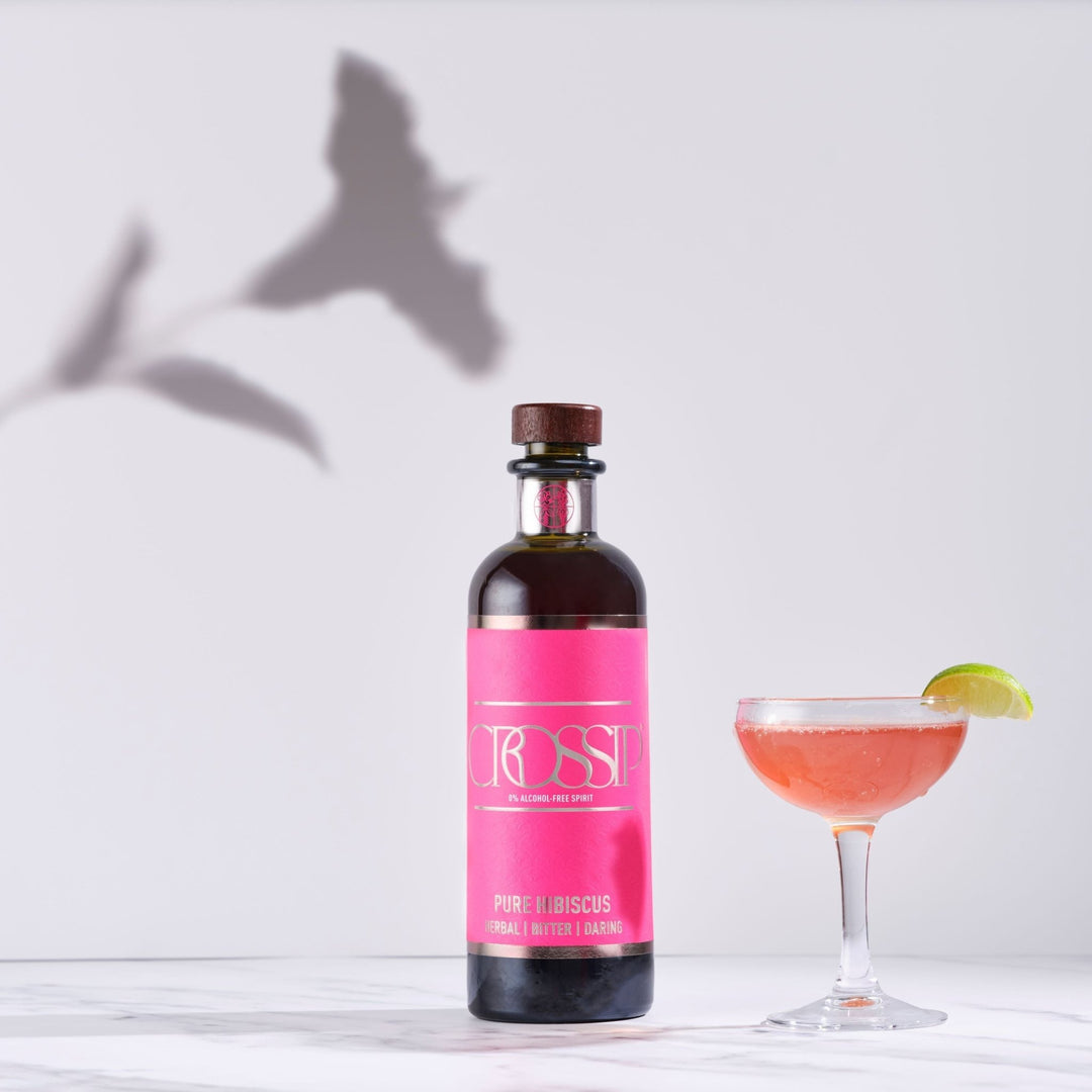 Bottle of Crossip Pure Hibiscus with a cocktail on a white background