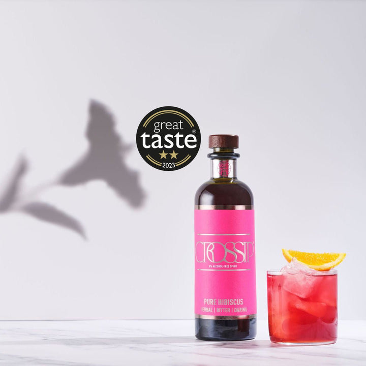 Bottle of Crossip Pure Hibiscus with a cocktail and 'Great Taste' award on a light background