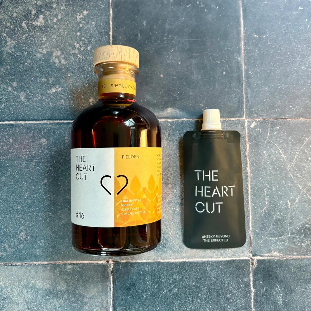 Bottle and 3cl pouch of 'The Heart Cut' #16 whisky on a tiled surface 