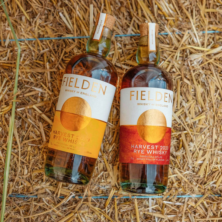 Two bottles of Fielden Harvest Rye Whisky on a bale of straw.