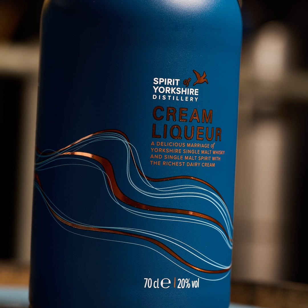 Blue bottle of Spirit of Yorkshire Cream Liqueur with wavy design