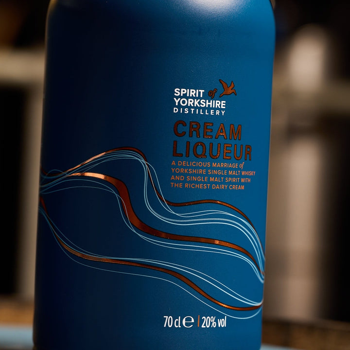 Blue bottle of Spirit of Yorkshire Cream Liqueur with wavy design