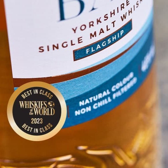 Bottle of Filey Bay Flagship Yorkshire Single Malt Whisky with a label featuring a gold award badge.