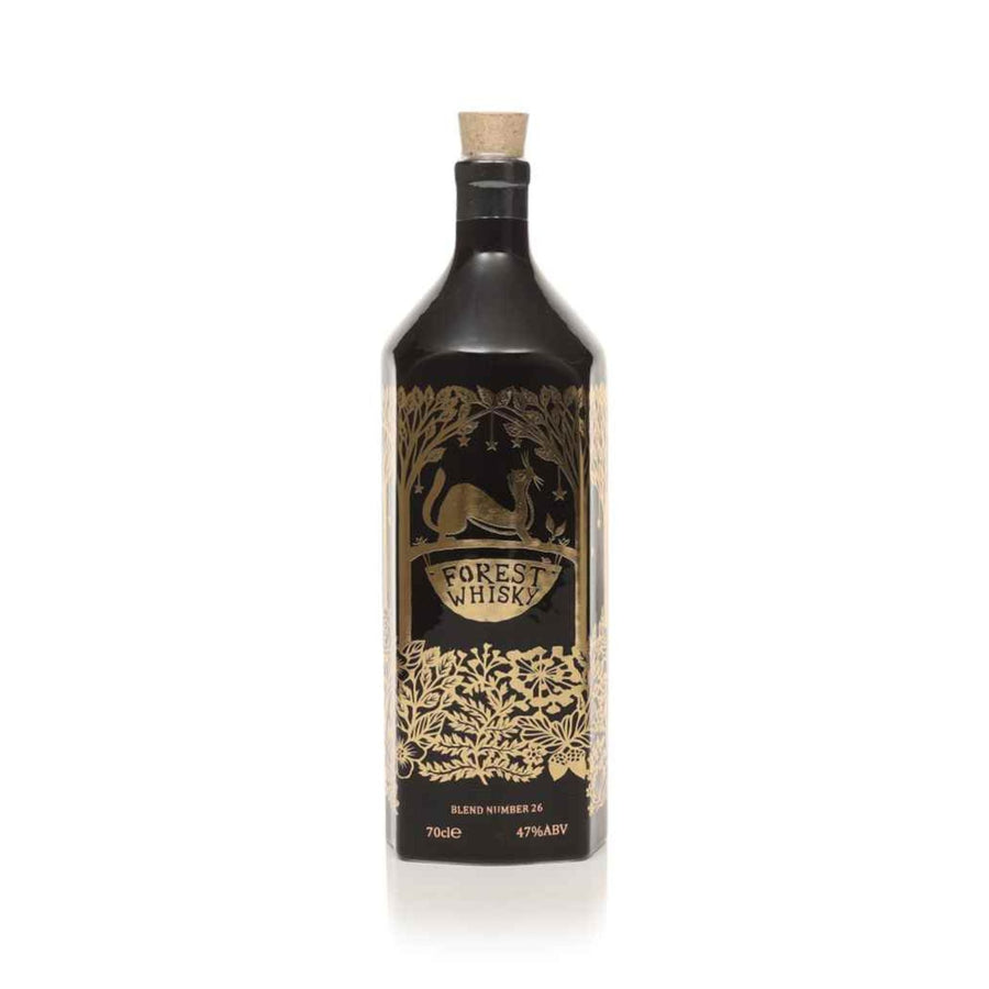 Black bottle of Forest Whisky with gold label on a white background