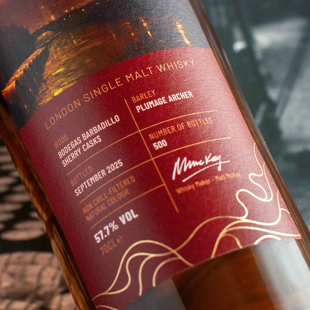 Bottle of Embarque London Single Malt Whisky with a detailed label with an old photo behind as background.