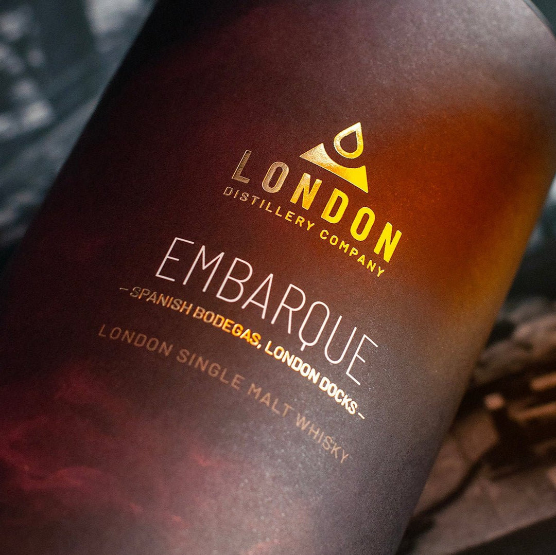 Whisky bottle with 'London Distillery Company' Embarque label on a dark background