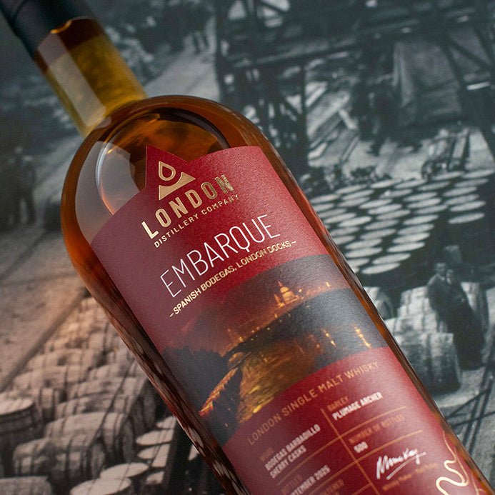 Bottle of London Distillery Company Embarque whisky with a vintage ship background