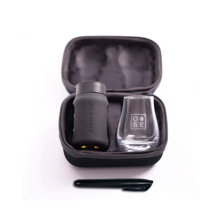 Oak and Ember Mini Glask Traveller Set with a glass, black container, and pen in an open case on a white background