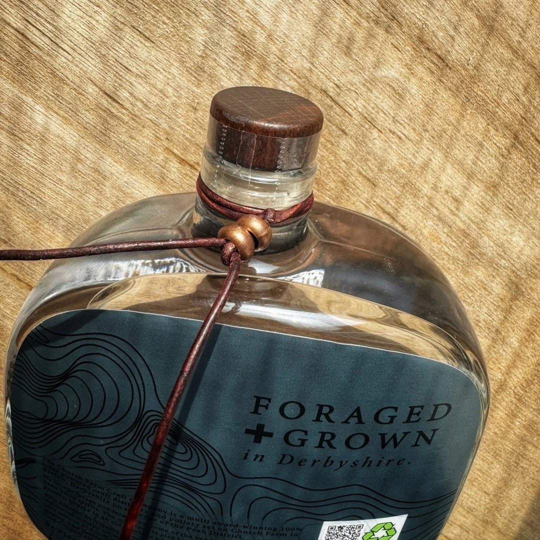 Close up shot of the neck tie on a bottle of The Church Farm Craft Company - Peak Heritage The Master of The Peak Gin, 70cl