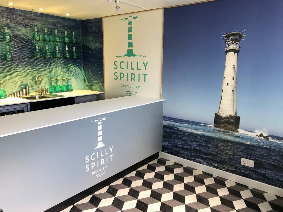 Interior of a building with 'Scilly Spirit' branding and a lighthouse mural.