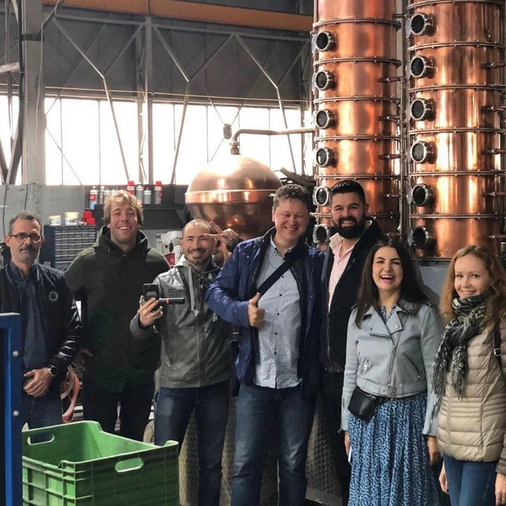 A group of people standing in the Somerset Spirits Co. distillery