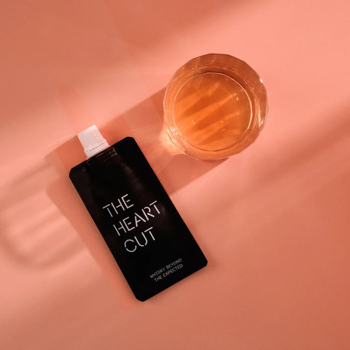 3cl whisky pouch labeled 'The Heart Cut' on a peach background