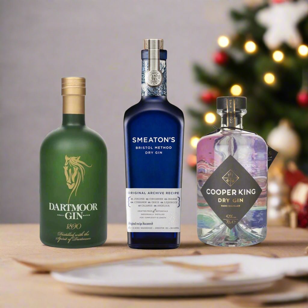 3 gin bottles from Dartmoor Gin, Smeaton's Bristol Dry Gin, and Cooper King Dry Gin on a christmas festive table background