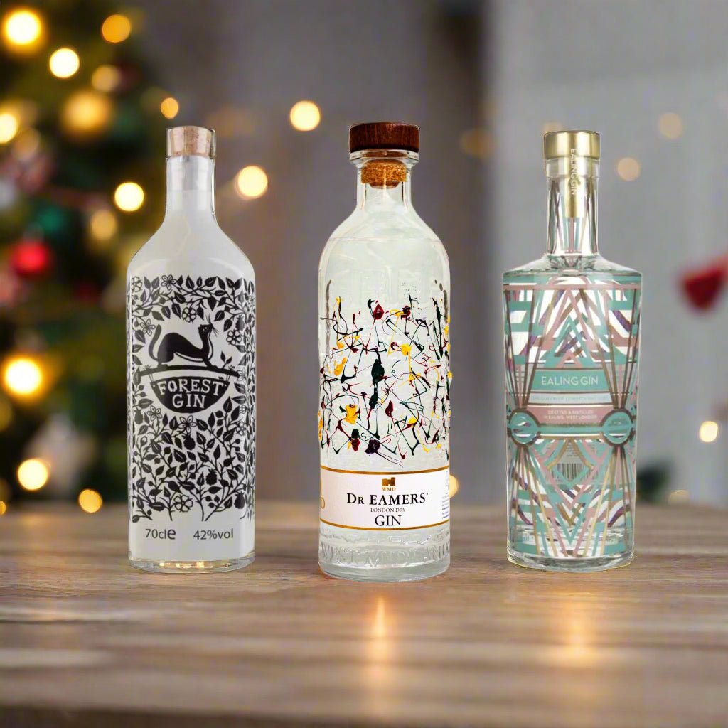 Three gin bottles with decorative labels in a Christmas themed room