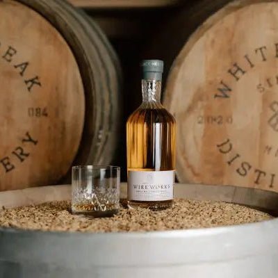 White Peak Wire Works Heritage Chevalier Bottle on barrel with glass 