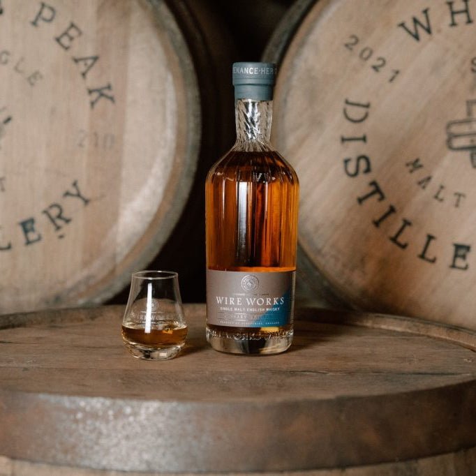 Wire Works Whisky Bottle on barrel top with glass