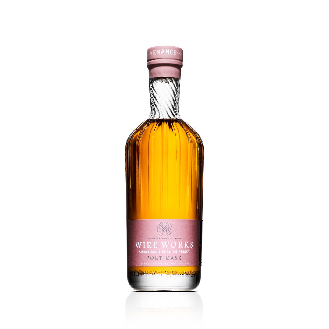 Bottle of Wire Works Port Cask whisky with a pink label on a white background