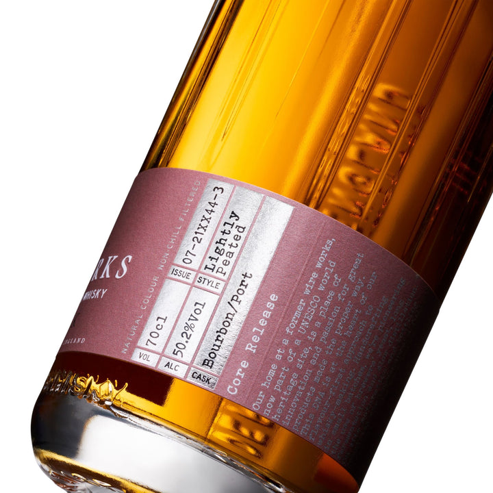 Close-up of a Wire Works Port Cask whisky bottle label with text and branding.
