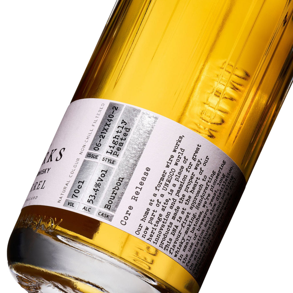 Close-up of a Wire Works Bourbon Barrel whisky bottle label with text and branding.