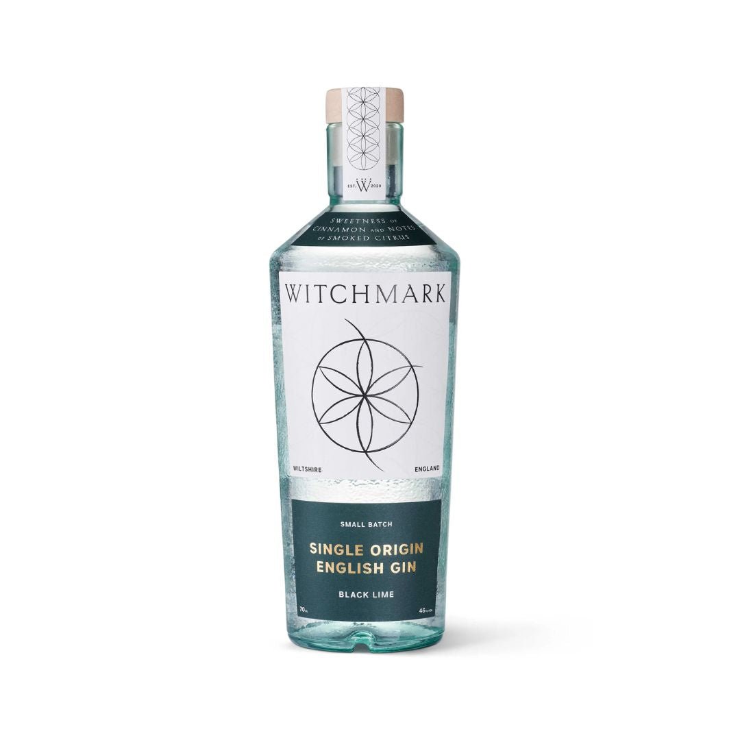 A bottle of Witchmark Black Lime Single Origin English Gin with a clear label and a witchmark design on the front.