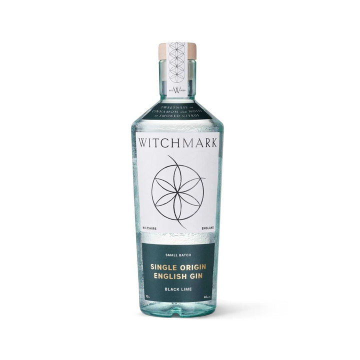 A bottle of Witchmark Black Lime Single Origin English Gin with a clear label and a witchmark design on the front.