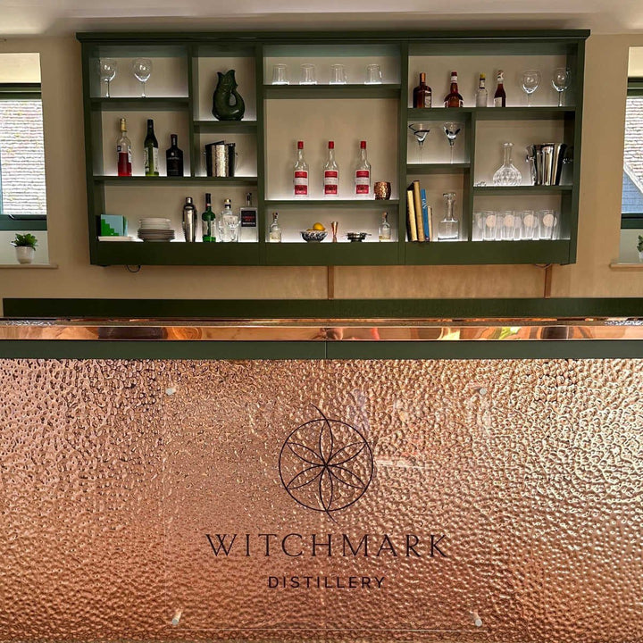 A close-up of a hammered copper bar front with the logo &